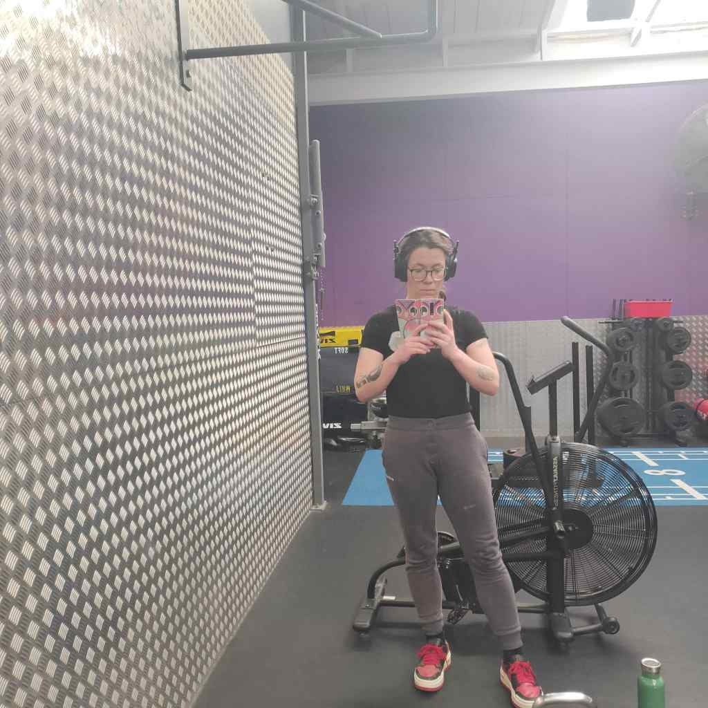 Picture of the author posing in a gym.